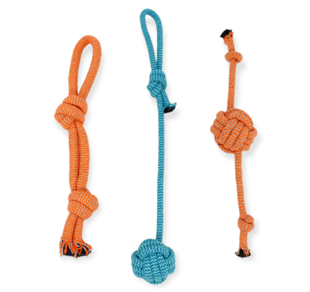 A collection of dog toys including a plush toy, three rope toys, a frisbee, and a treat ball. The toys are designed to relieve boredom and provide entertainment for dogs. This dog toy box is a perfect birthday gift for dog lovers and their furry friends. The toys are brightly colored and made from high-quality materials to ensure durability and long-lasting fun.